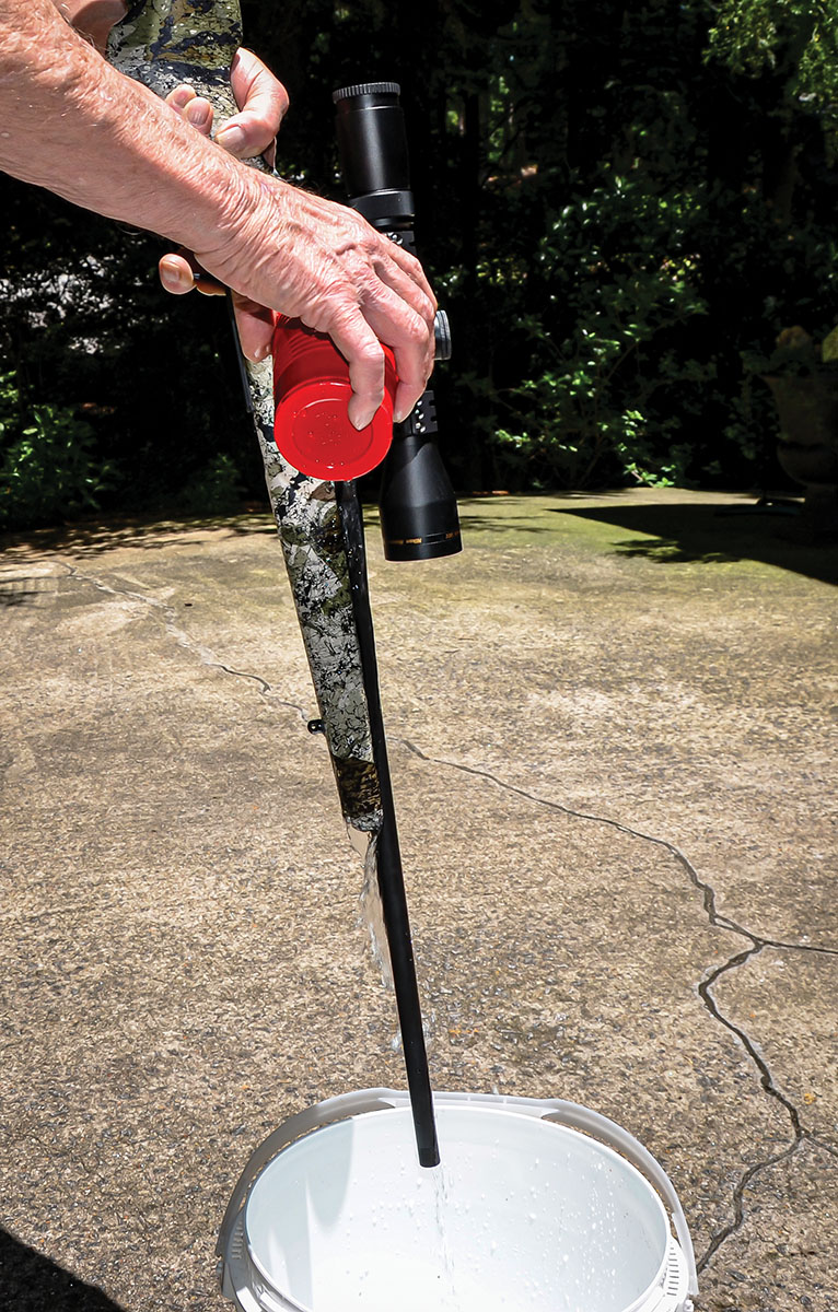 If a rifle has a synthetic stock, its barrel can be cooled by holding it muzzle down over a bucket and pouring water down the outside of the barrel. A downside to this method is the part of the barrel resting in the forearm of the stock is mainly cooled on its exposed surface while the rest of the barrel, out to its muzzle, is cooled all around. This has no negative affect on some  rifles while others require a warm-up shot prior to shooting a test group.